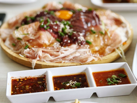 Pork sashimi with kimchi and miso sauceの写真素材