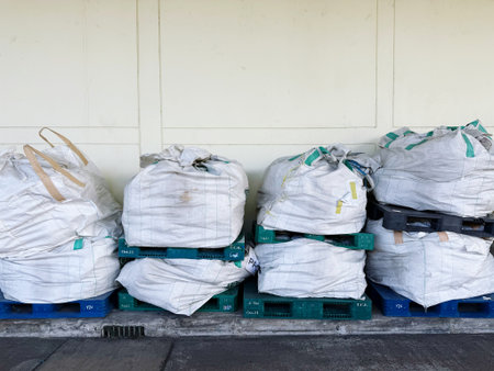 Pile of plastic bags on wooden pallet, ready for shipmentの写真素材