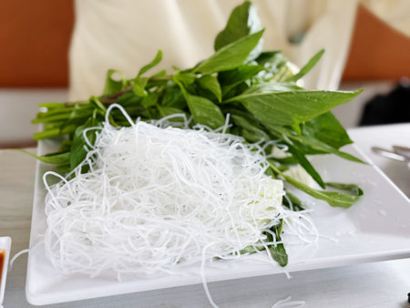 rice vermicelli in white plate on table in a restaurant