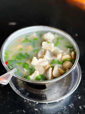 chicken soup in a metal pot on the table, stock photoの写真素材
