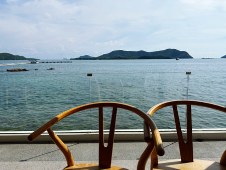 Wooden table and chair on the deck of a cruise ship in Thailandの写真素材