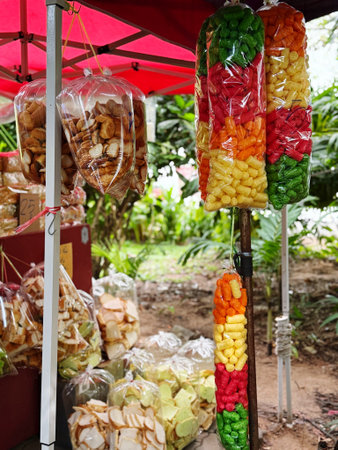 Colorful candied fruits in plastic bags on street food stall.の写真素材