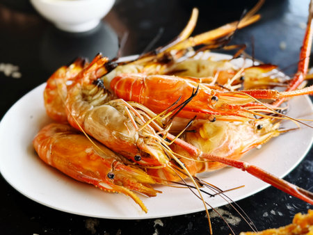 Grilled tiger prawns on a white plate, Thailand.の写真素材
