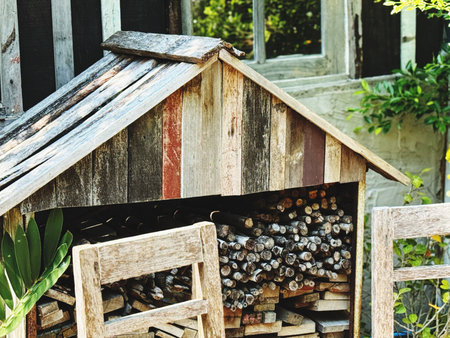 Wooden house with firewood in the garden. Selective focus.