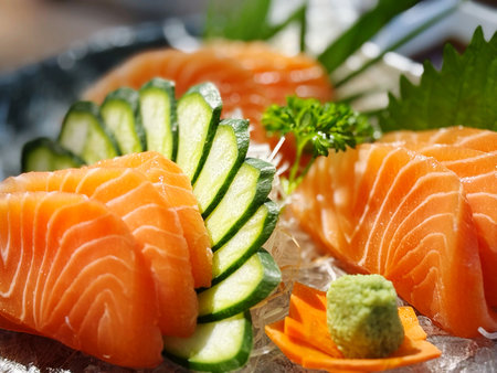 Sashimi of salmon and cucumber on a plate close upの写真素材