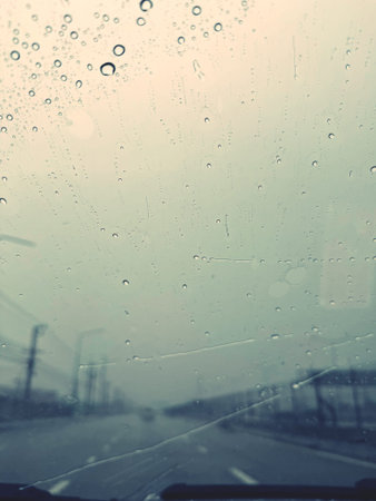 Rain drops on the car windshield. Shallow depth of field.の写真素材