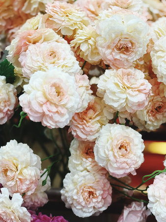 Beautiful artificial roses in a flower shop. Floral background.の写真素材