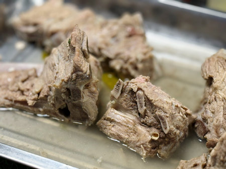 Beef being prepared on a metal tray, close-upの写真素材