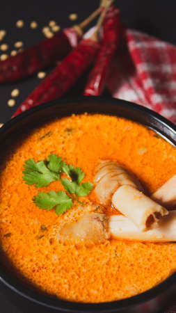 Closeup view of Indian style spicy Mutton or Lamb curry with spices, Portrait view, Flat layの写真素材