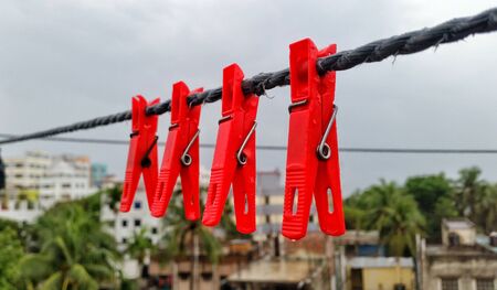 Clothes drying using clips red colourの写真素材