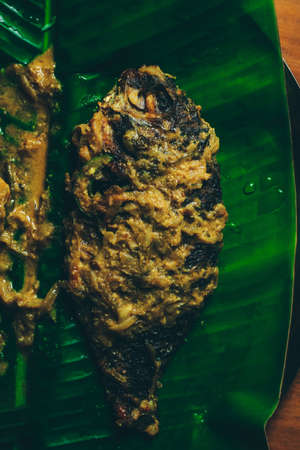 Bengali fish curry, Telapia on banana leaf, selective focusの写真素材