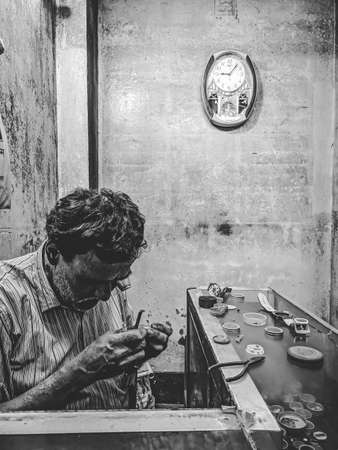 Netrakona ,Bangladesh .5.11.2021 watchmaker try to repair watch with his tools - can use to display or montage on productsのeditorial素材