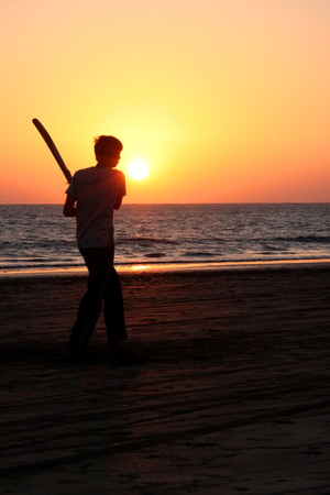 Playing cricket on the beachの写真素材