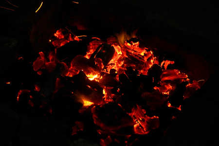 Hot sparking live-coals burning in a barbecueの写真素材
