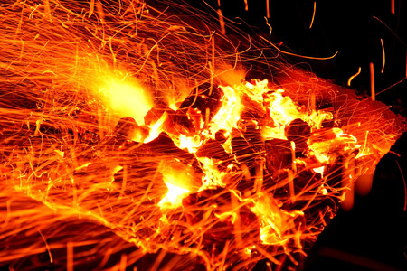Hot sparking live-coals burning in a barbecueの写真素材