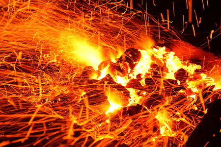 Hot sparking live-coals burning in a barbecueの写真素材