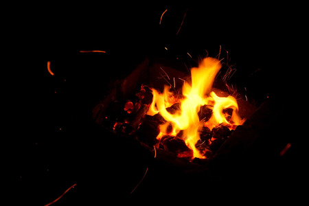 Hot sparking live-coals burning in a barbecue