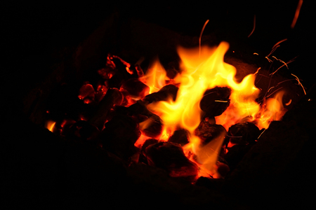 Hot sparking live-coals burning in a barbecueの写真素材