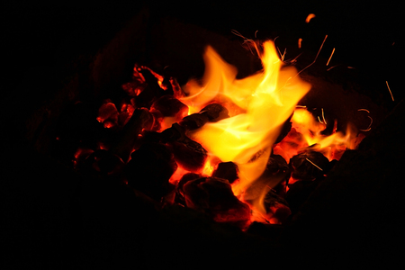Hot sparking live-coals burning in a barbecueの写真素材