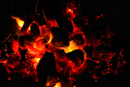 Hot sparking live-coals burning in a barbecueの写真素材
