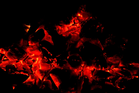 Hot sparking live-coals burning in a barbecueの写真素材