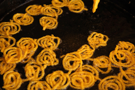 Delicious jalebi frying in oil panの写真素材