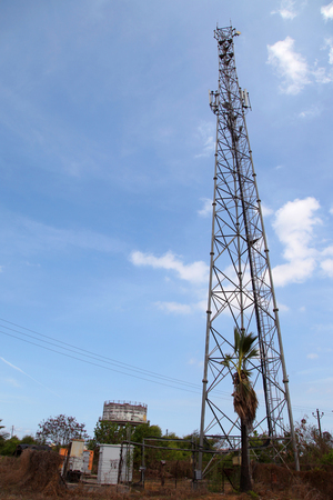 Mobile phone communication tower transmission signal with blue sky and antennaの写真素材