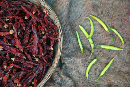 Pile of dried red and green chili peppers background, top view.の写真素材