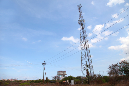 Mobile phone communication tower transmission signal with blue sky and antennaの写真素材