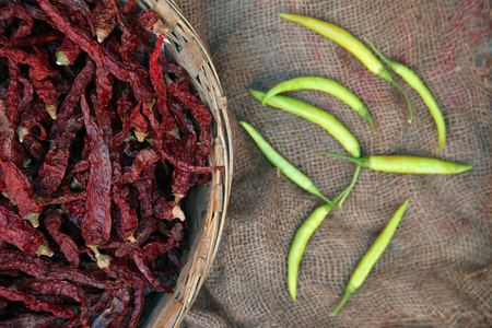 Pile of dried red and green chili peppers background, top view.の写真素材