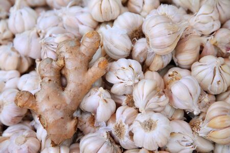 piles of ginger and Garlic in the market of indiaの写真素材
