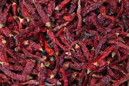 Pile of dried red chili peppers background, top view.の写真素材