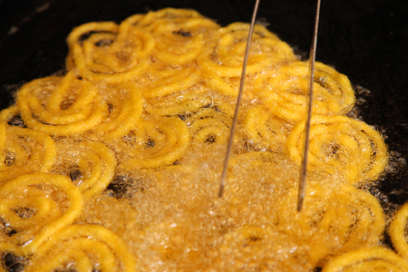 Delicious jalebi frying in oil panの写真素材