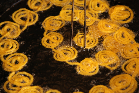 Delicious jalebi frying in oil panの写真素材