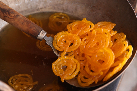 Delicious jalebi frying in oil panの写真素材