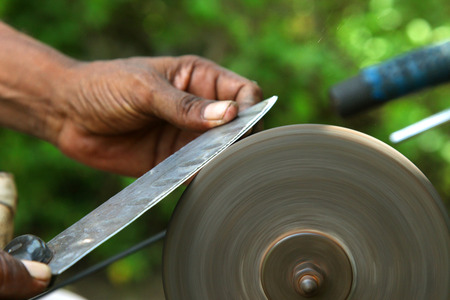 sharpening the knife with whetstoneの写真素材