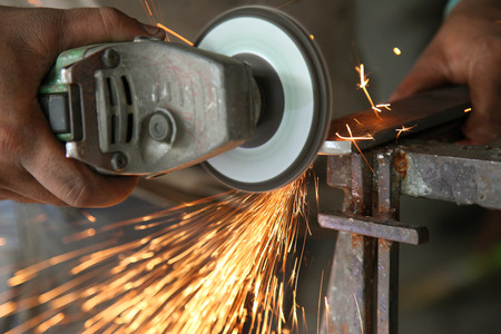 Metal works. Electric wheel grinding on steel structure in factoryの写真素材