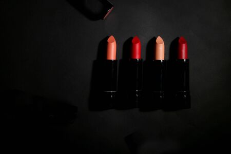 Lipstick. Fashion Colorful Lipsticks over black background. Lipstick tints palette, Professional Makeup and Beauty. Beautiful Make-up concept. Lipgloss. Lipsticks closeupの写真素材