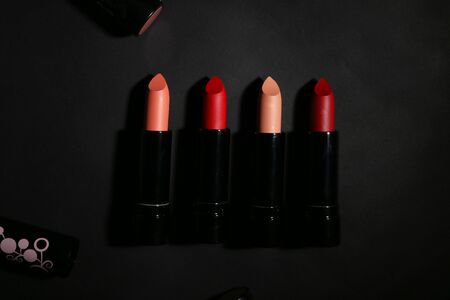Lipstick. Fashion Colorful Lipsticks over black background. Lipstick tints palette, Professional Makeup and Beauty. Beautiful Make-up concept. Lipgloss. Lipsticks closeupの写真素材