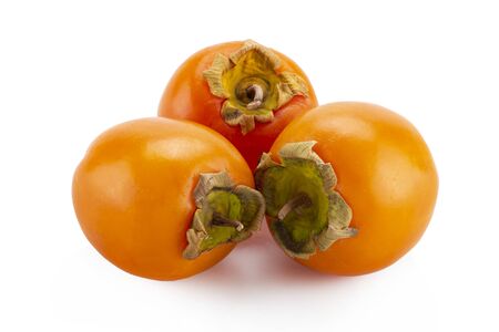 fresh ripe persimmons with leaf isolated on white background. full depth of fieldの写真素材