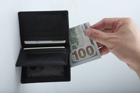 businessman saving money, Close up man carrying a wallet in hand, the dollar,finance accounting conceptの写真素材