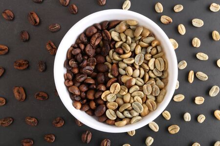 Coffee beans and bowl on stone background. Top view with copy space for your textの写真素材
