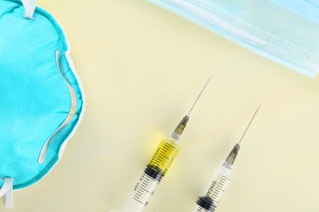 Covid-19 vaccine test and blood sample carry in tube glass decorate with injection syringe and mask...