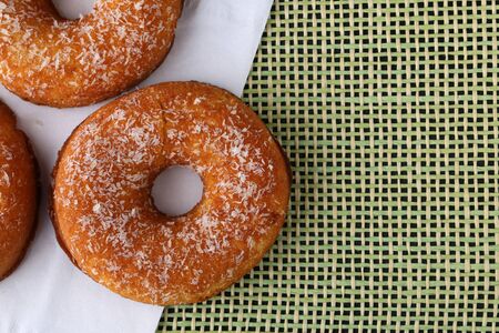 Polish donut,traditional sweet donuts on black background. Delicious, but unhealthy food on the old wooden table with copy spaceの写真素材