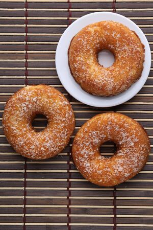 Polish donut,traditional sweet donuts on black background. Delicious, but unhealthy food on the old wooden table with copy spaceの写真素材