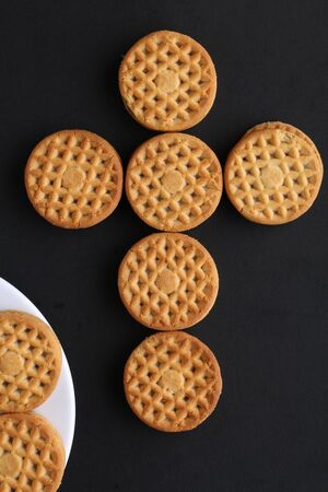 cookie close-up on a plate on a table. vertical view from above