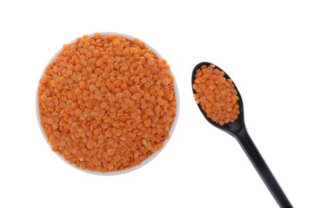 Close up of Orange Masoor Dal (Red Chief) lentil lens isolated on white background with Spoon.の写真素材