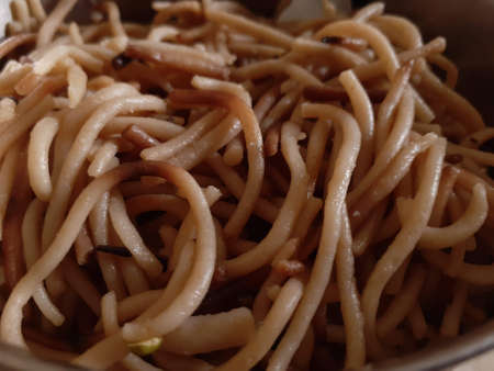 A close up of pasta in a pile of fries. High quality photoの写真素材