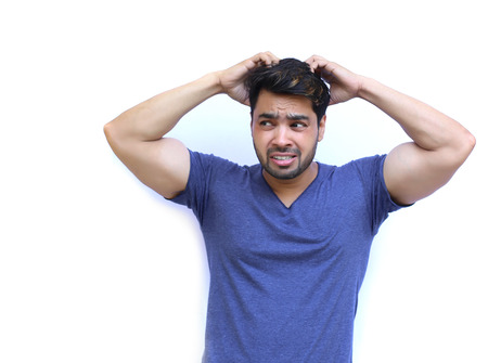 Young Indian Confused man scratching head - isolated white backgroundの写真素材