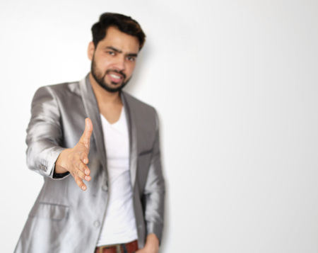 Young indian buisnessman with open hand ready for handshakeの写真素材